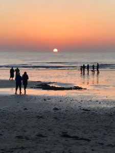 people-on-beach-at-sunrise